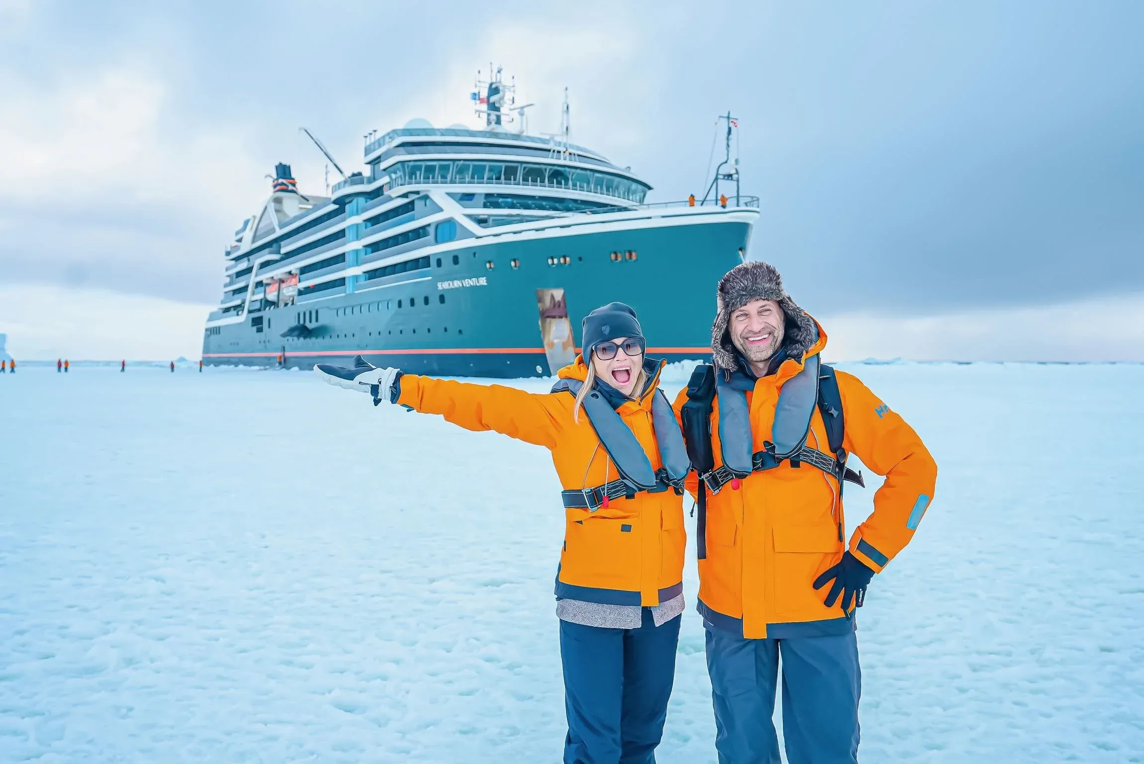 Phil and Erin Lockwood pose in front of an ice landing cruise ship in Antarctica