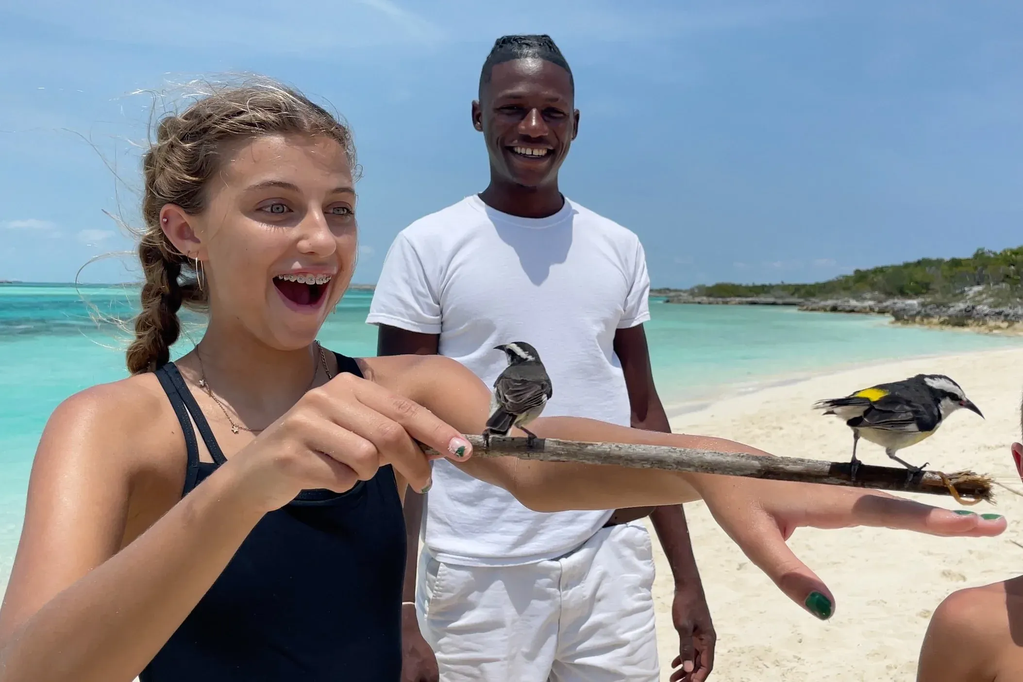 Reagan Lockwood plays with a bird in the Bahamas