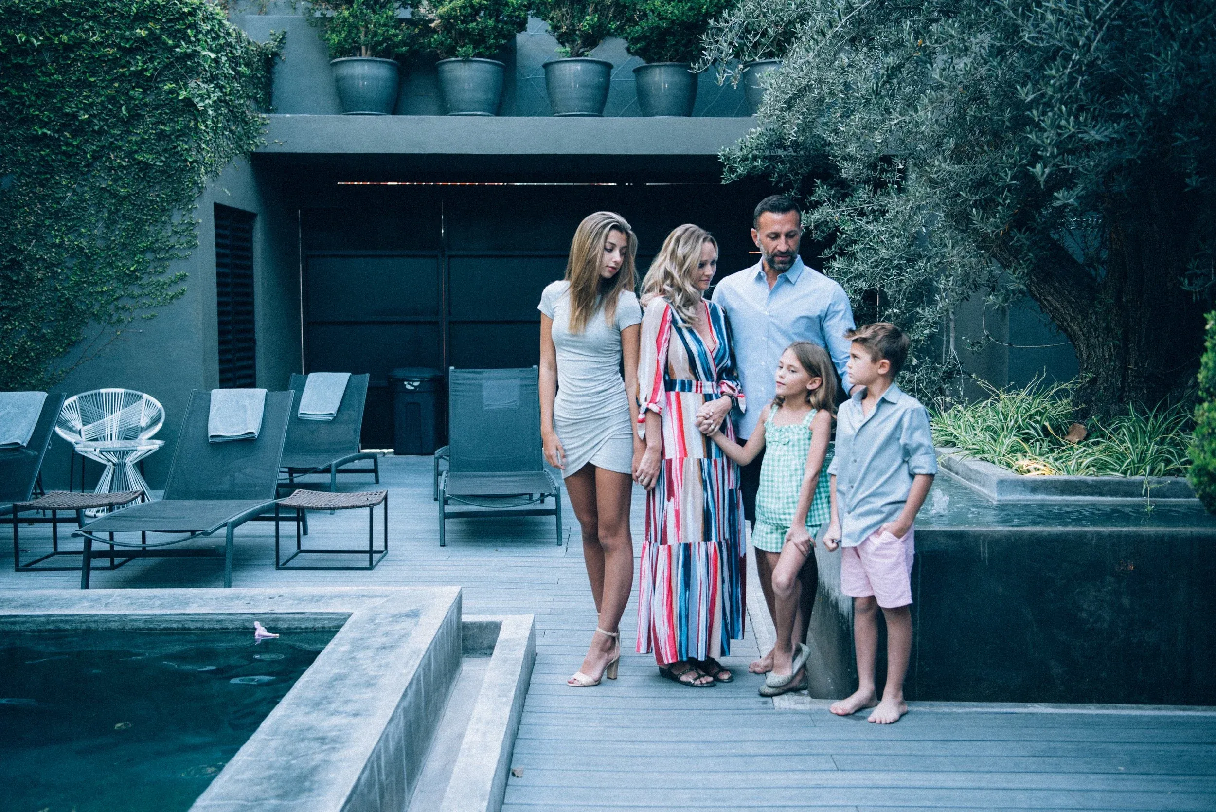 The Lockwood family standing by a pool