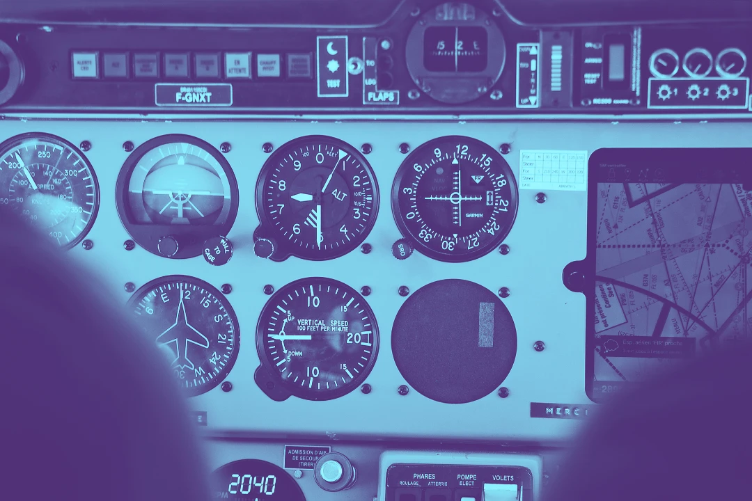 photo of an airplane's control dashboard with gauges and indicators