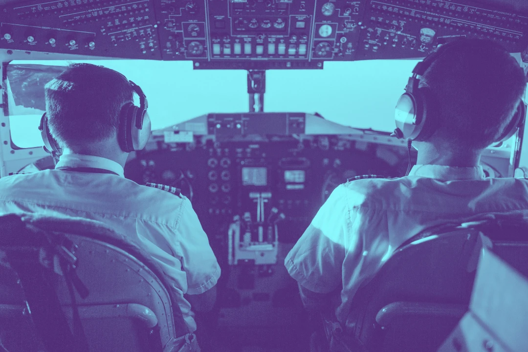 photo of a pilot and copilot inside an airplane cabin