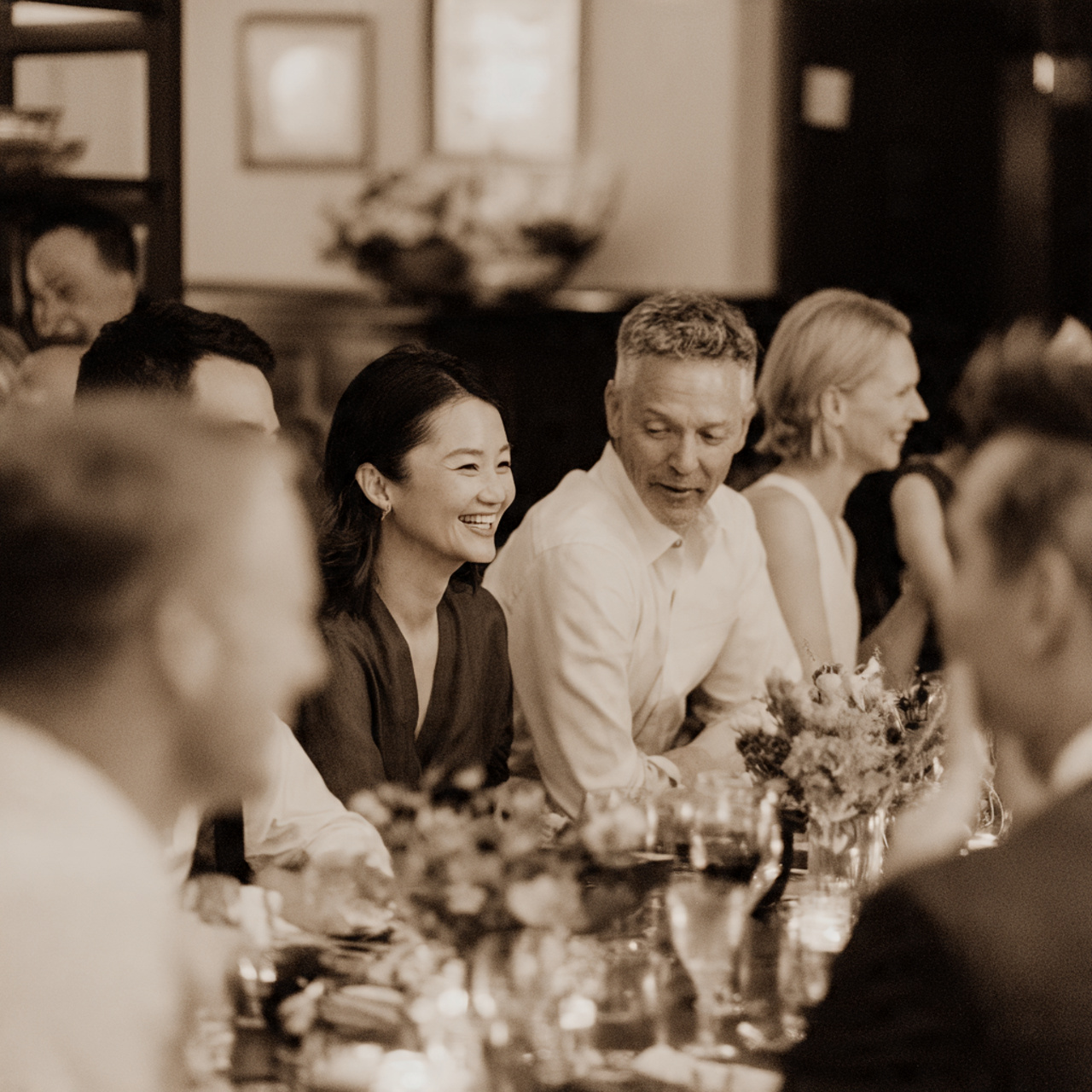 Group of people sitting at table engaging in conversation