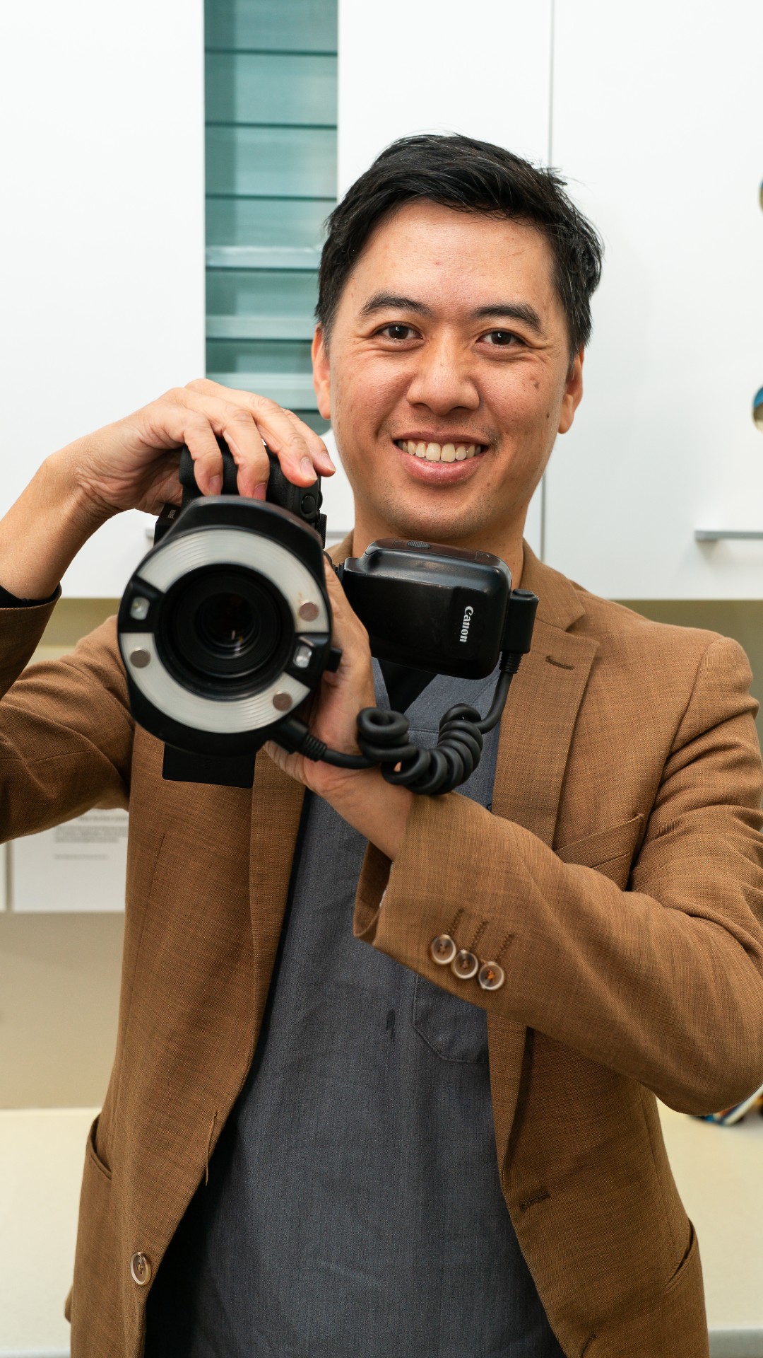 Patient viewing smile transformation in mirror after cosmetic dentistry