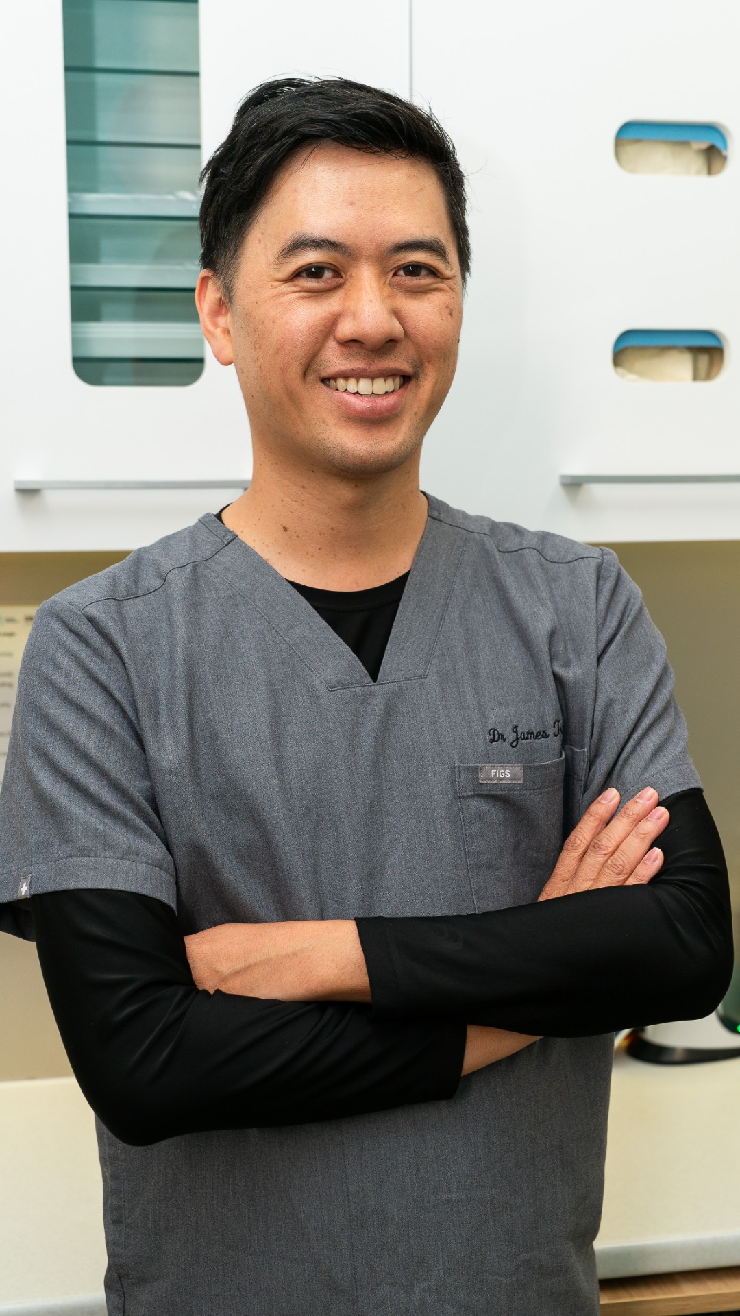 Dr James Tran in clinical scrubs ready to welcome patients for routine check-ups