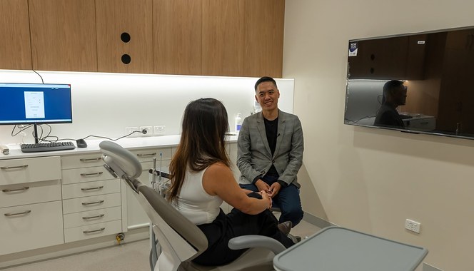 A dentist talking with a patient before treatment