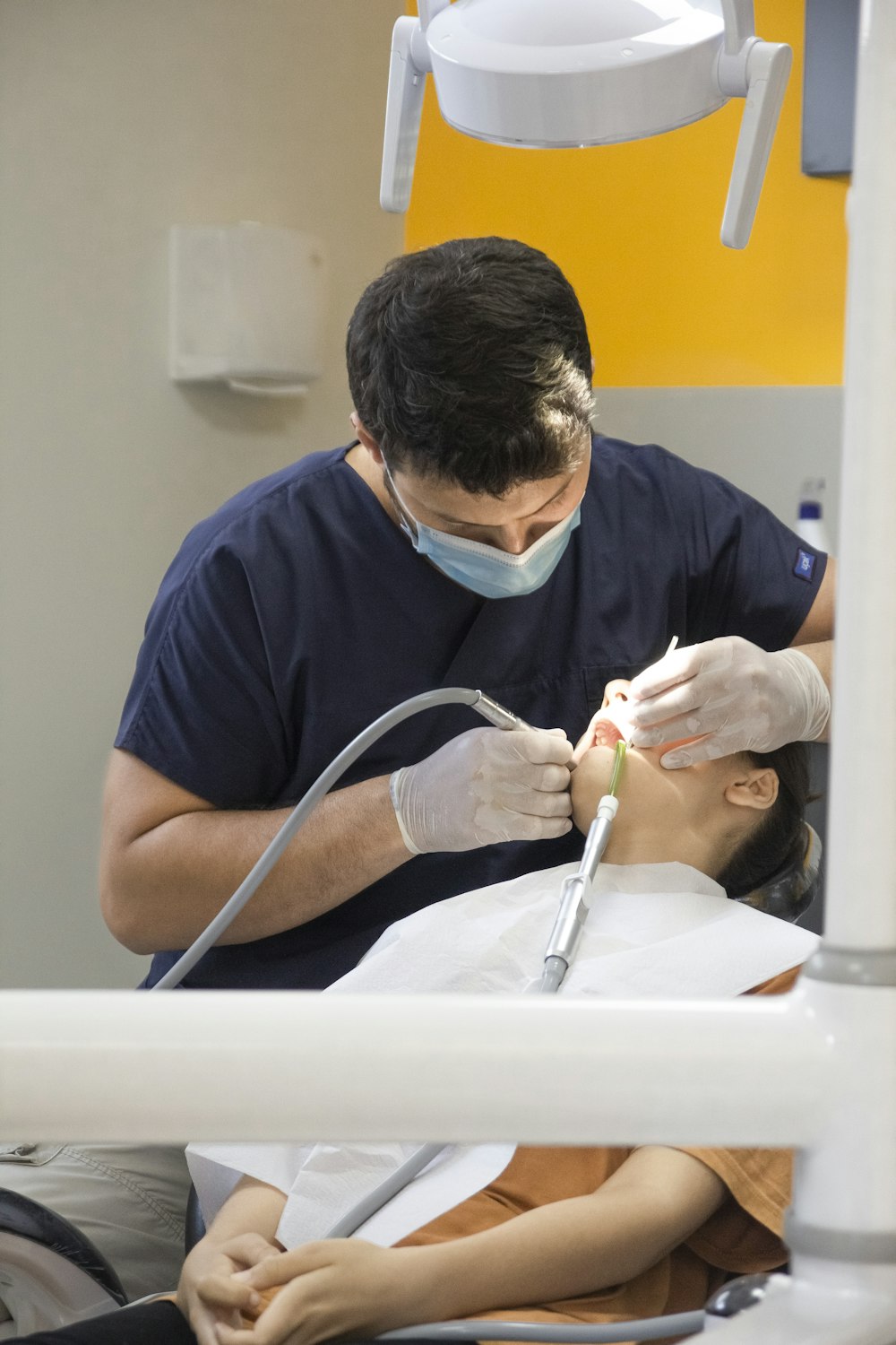Custom-fitted night guard designed to protect teeth from grinding, shown next to dental tools