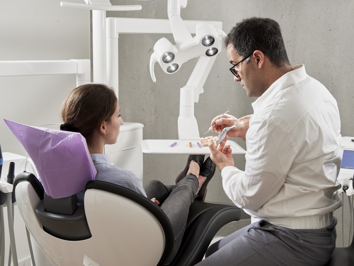 Dentist consulting with a patient about a chipped tooth after using an at-home tooth repair kit