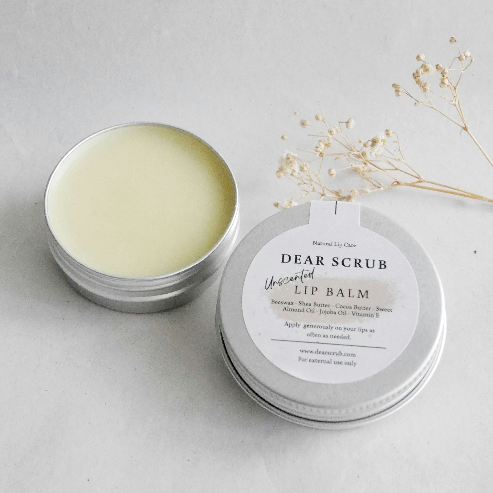 Lip balm beside a flower, relevant to lip care for musicians