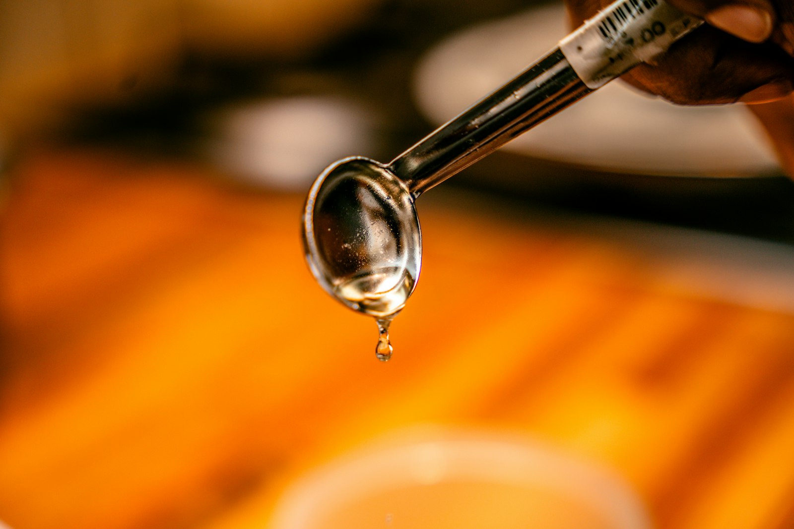 Person rinsing their mouth with a glass of water after taking liquid medicine