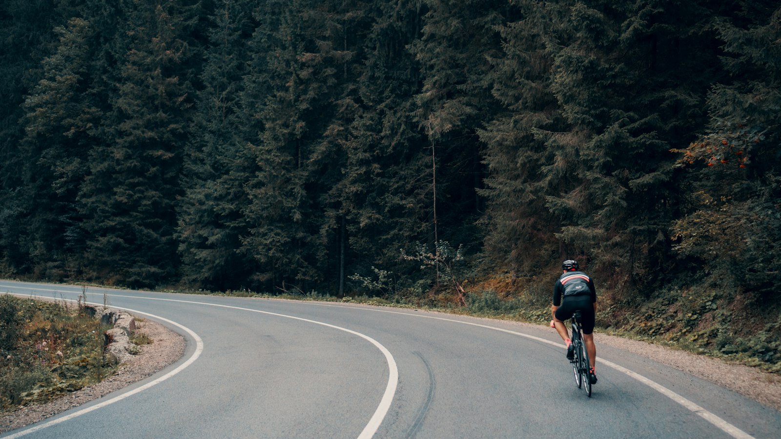 Cyclist checking their face and mouth after a fall on a gravel road