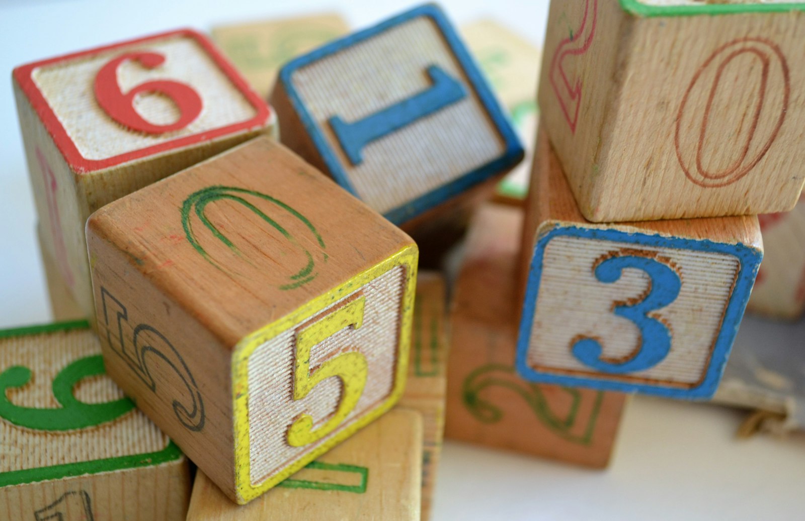 Close-up of brown wooden toy blocks in a playroom, a reminder that childcare workers face daily knocks that can affect teeth