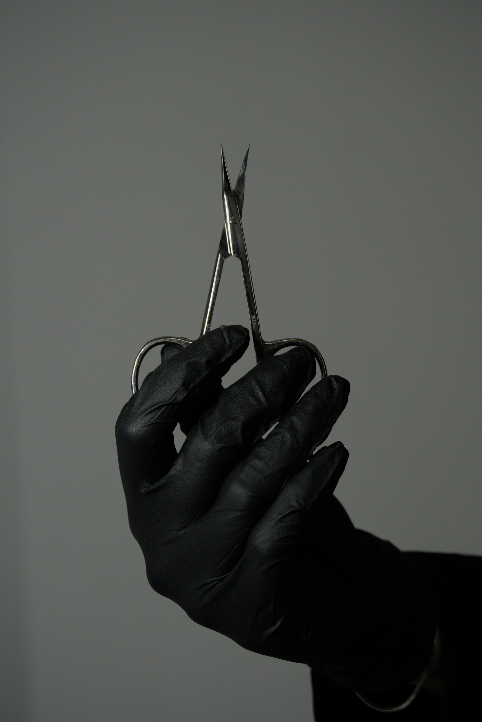 Nail technician working at a salon table, a common setting for nail technician dental health habits