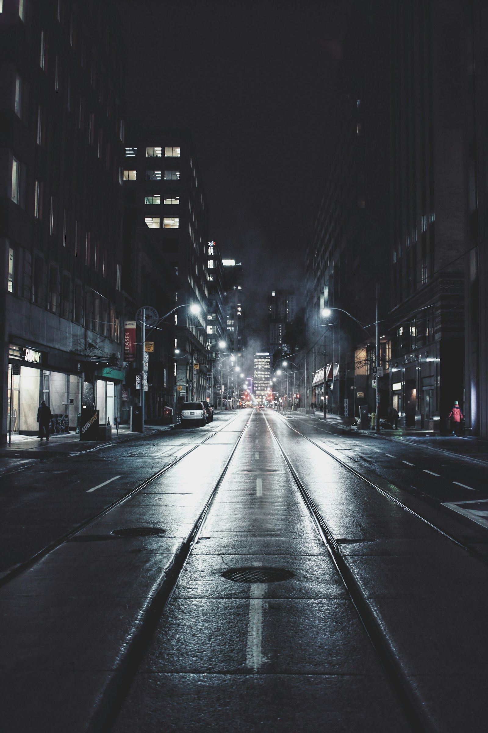 Empty city road at night, the kind of overnight setting where security guards dental health routines are easy to skip