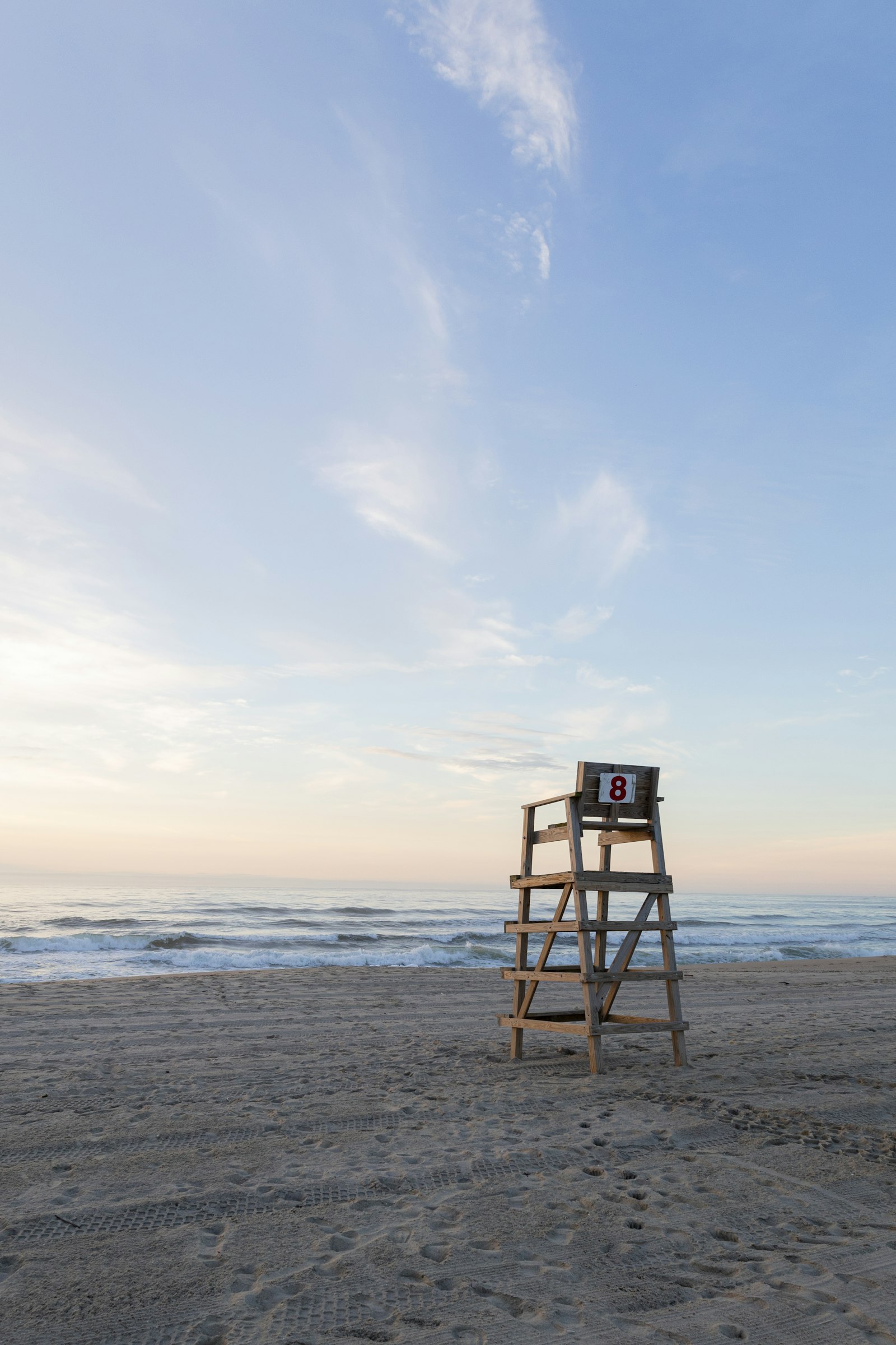 Lifeguard chair on a beach beside the ocean, a sunny workplace where lifeguards and swim instructors need to look after their dental health