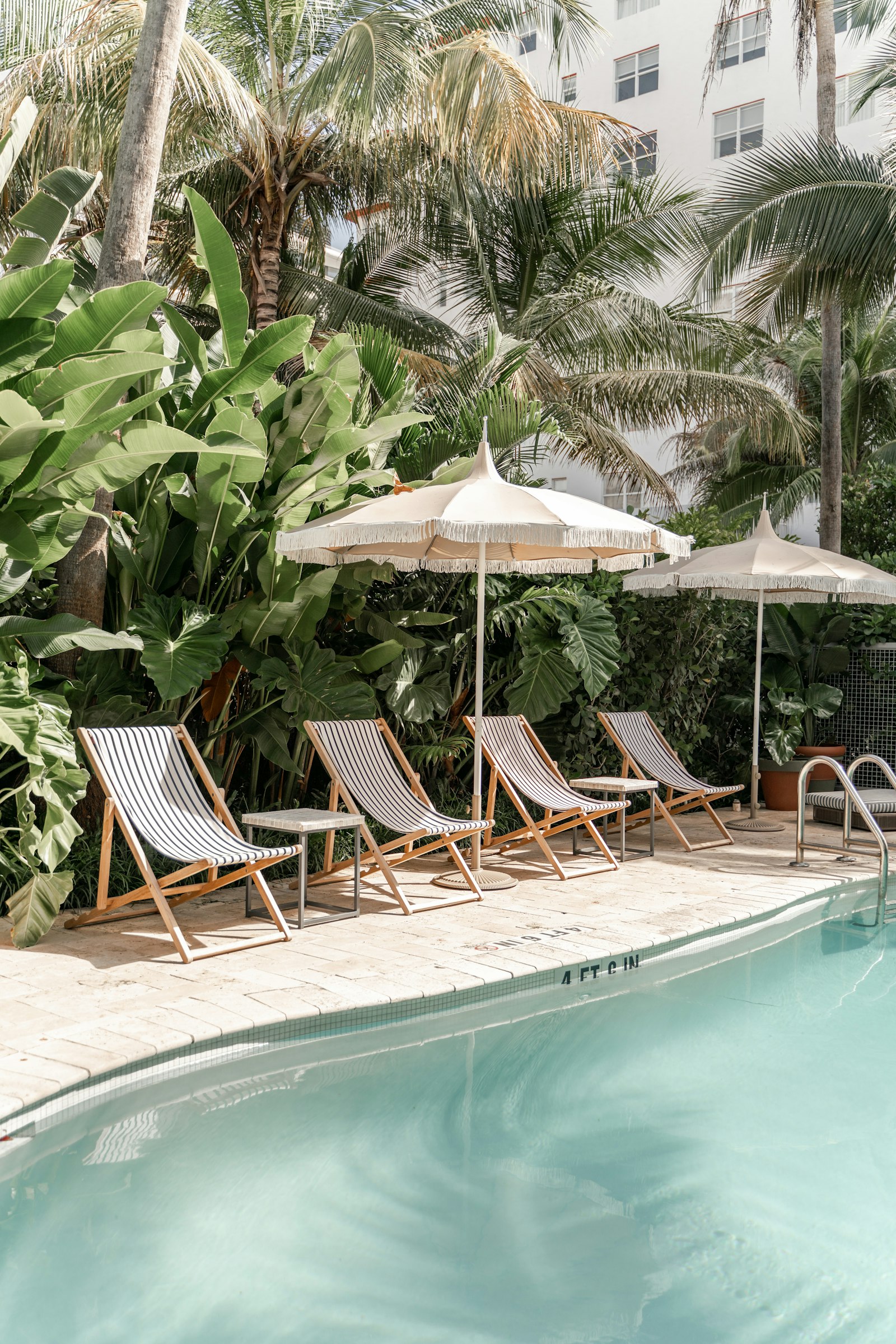 Empty poolside chairs beside a swimming pool, a workplace where lifeguards and swim instructors protect their dental health
