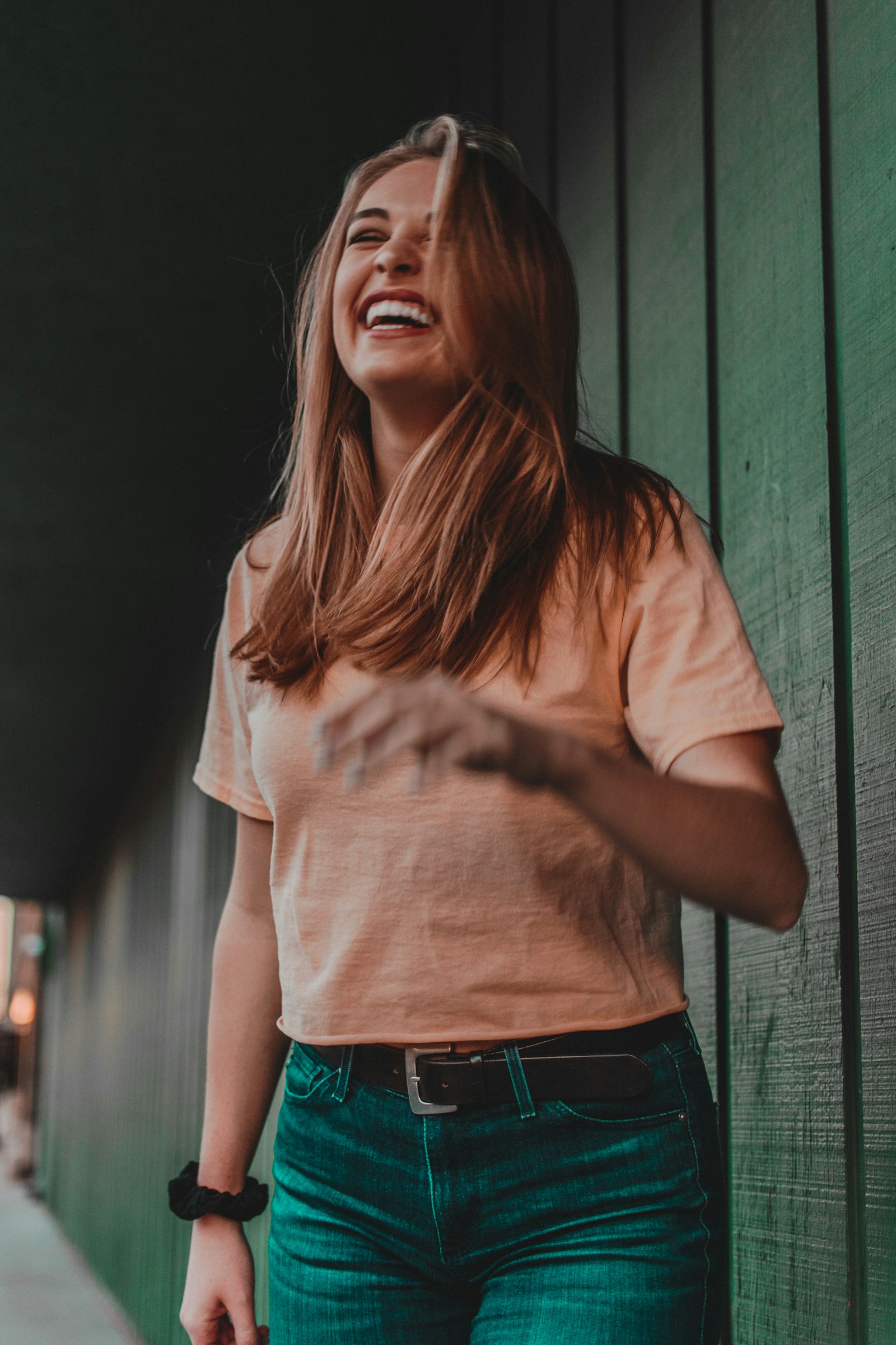Woman in a peach top laughing, natural teeth whitening remedies explained