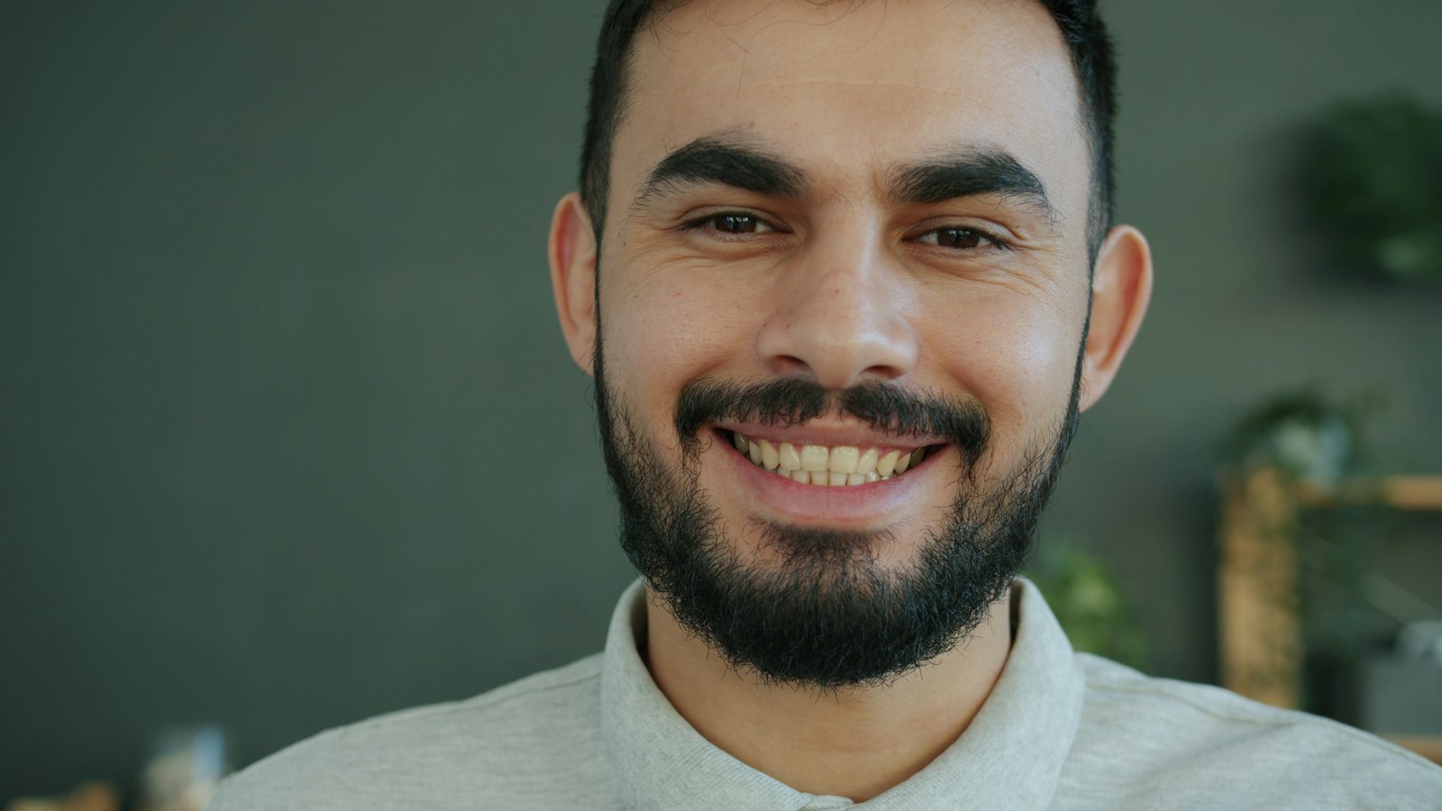 Smiling man with even front teeth, illustrating tooth proportions in smile design