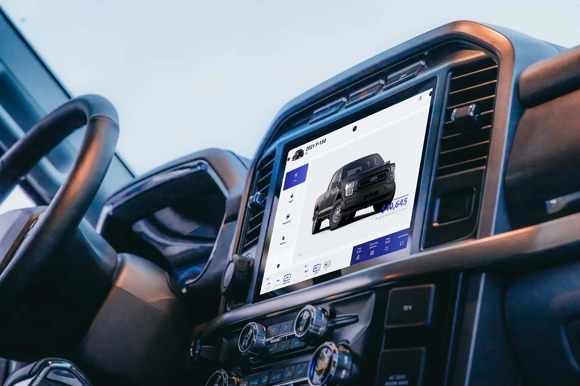 Car dashboard touchscreen displaying a 2021 Ford F-150 truck and pricing information.