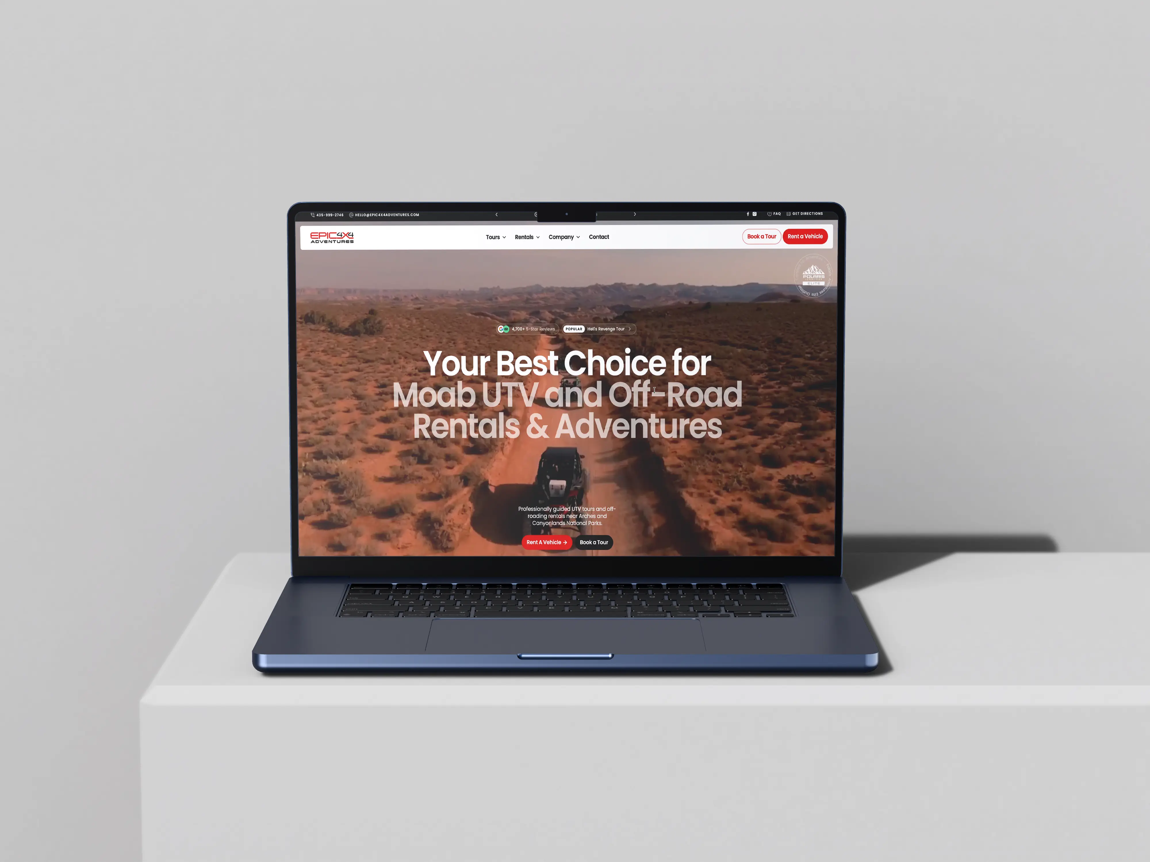 Laptop displaying a website for Moab UTV and off-road rentals and adventures with a desert trail and vehicle image.