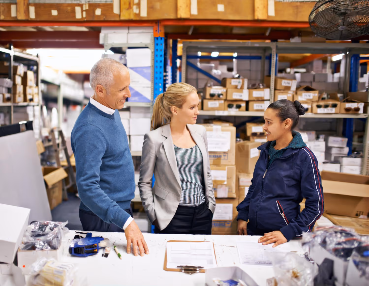 A stock image showing three people inside a fulfilment centre