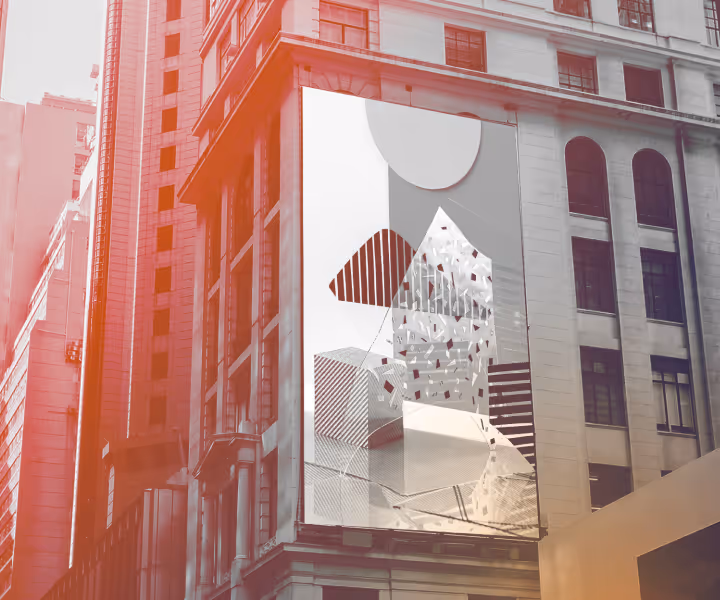 Large abstract geometric art with shapes and patterns on a city building wall.
