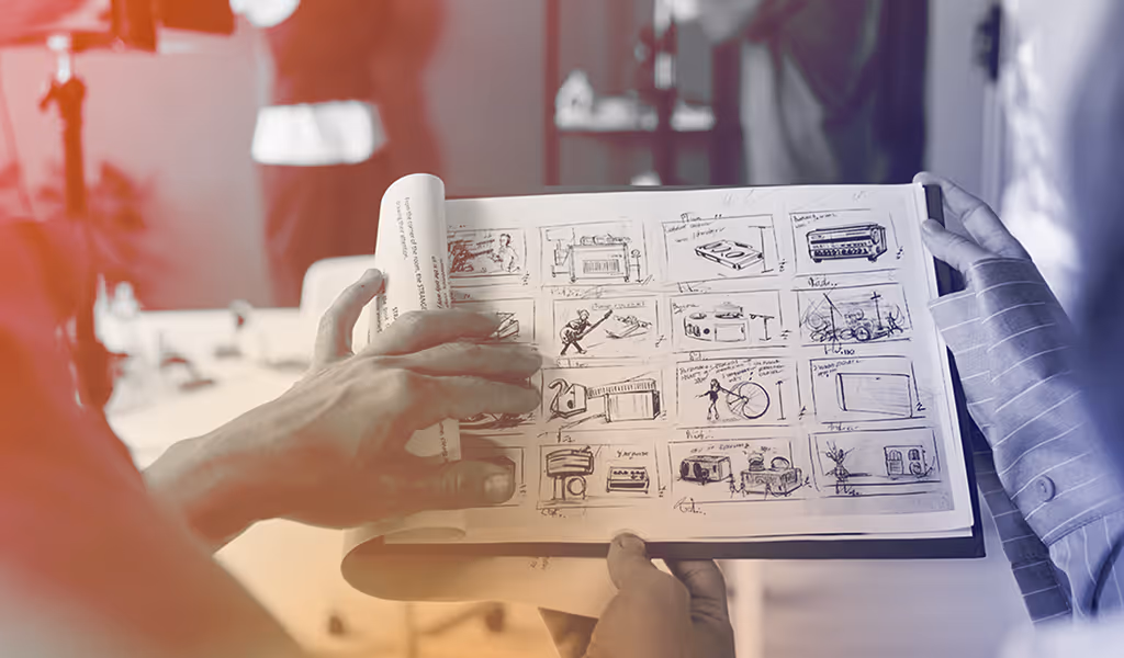 Two people reviewing a storyboard with hand-drawn sketches and notes in a blurred office setting.