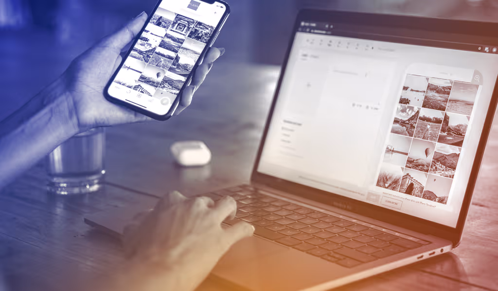 Person browsing photo gallery on smartphone while using laptop with photo thumbnails on screen.