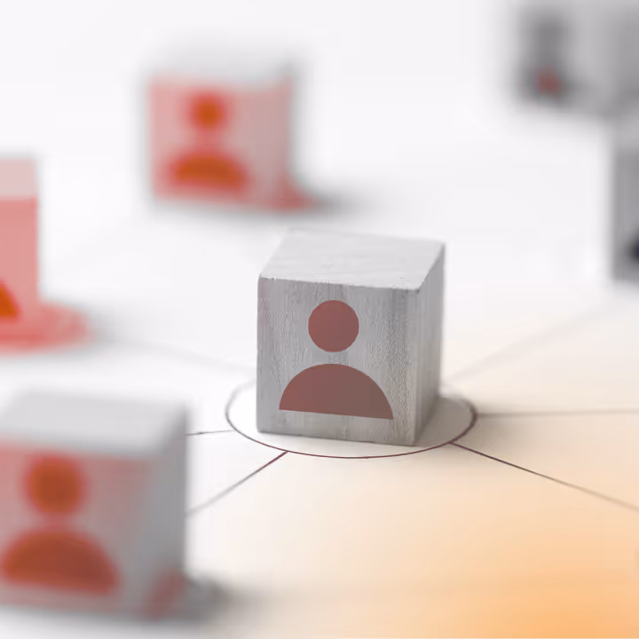Wooden blocks with person icons connected by lines, symbolizing community and networking.
