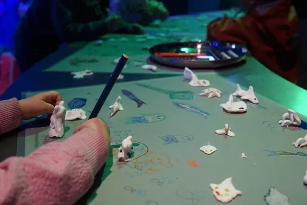 En manetfigur som henger i en tentakkel på en ledning, som illustrasjonsbilde for beskrivelsen av kunstcamp Havskilpadden med kunstpilotene på Akvariet i Bergen