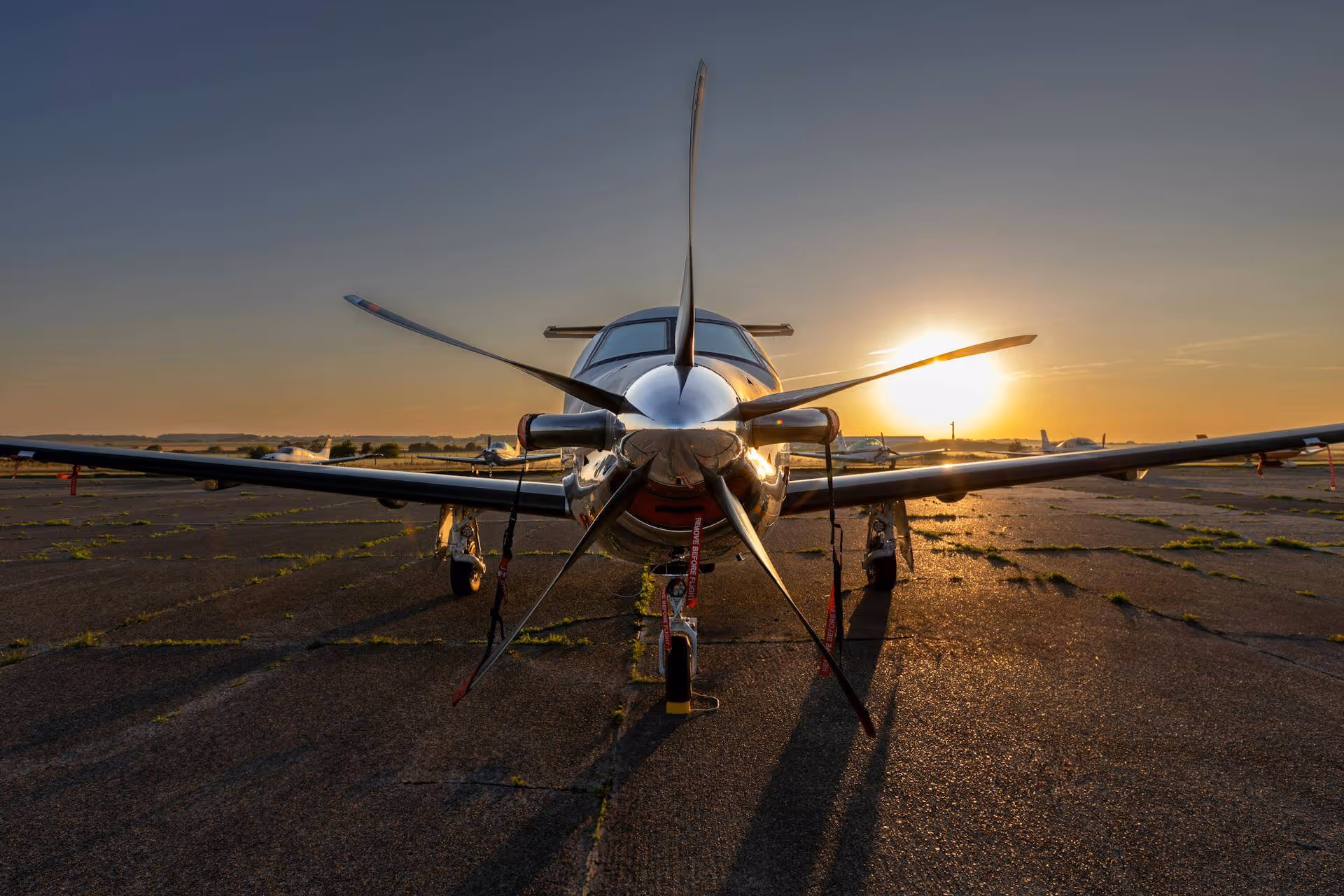 A propeller plane is parked on the runway
