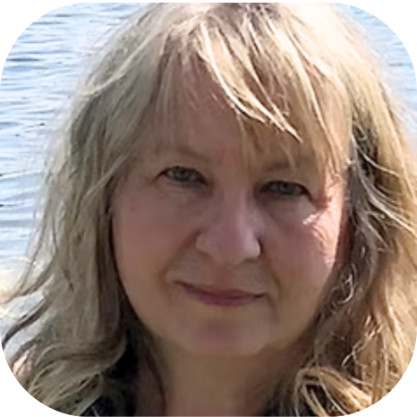 Close-up of a woman with blonde hair standing outdoors near water.
