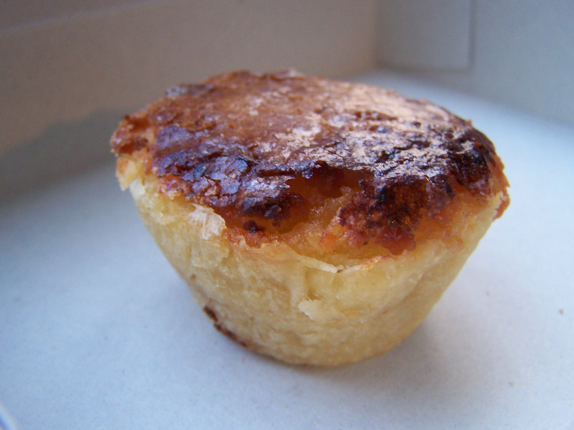 Pastel de feijão de Torres Vedras, petite tartelette dorée à la crème de haricots blancs, gros plan sur une assiette, pâtisserie traditionnelle portugaise
