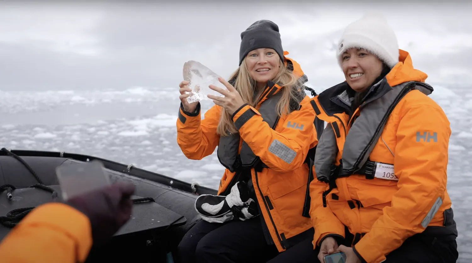 Antarctic explorer holding up glacier ice
