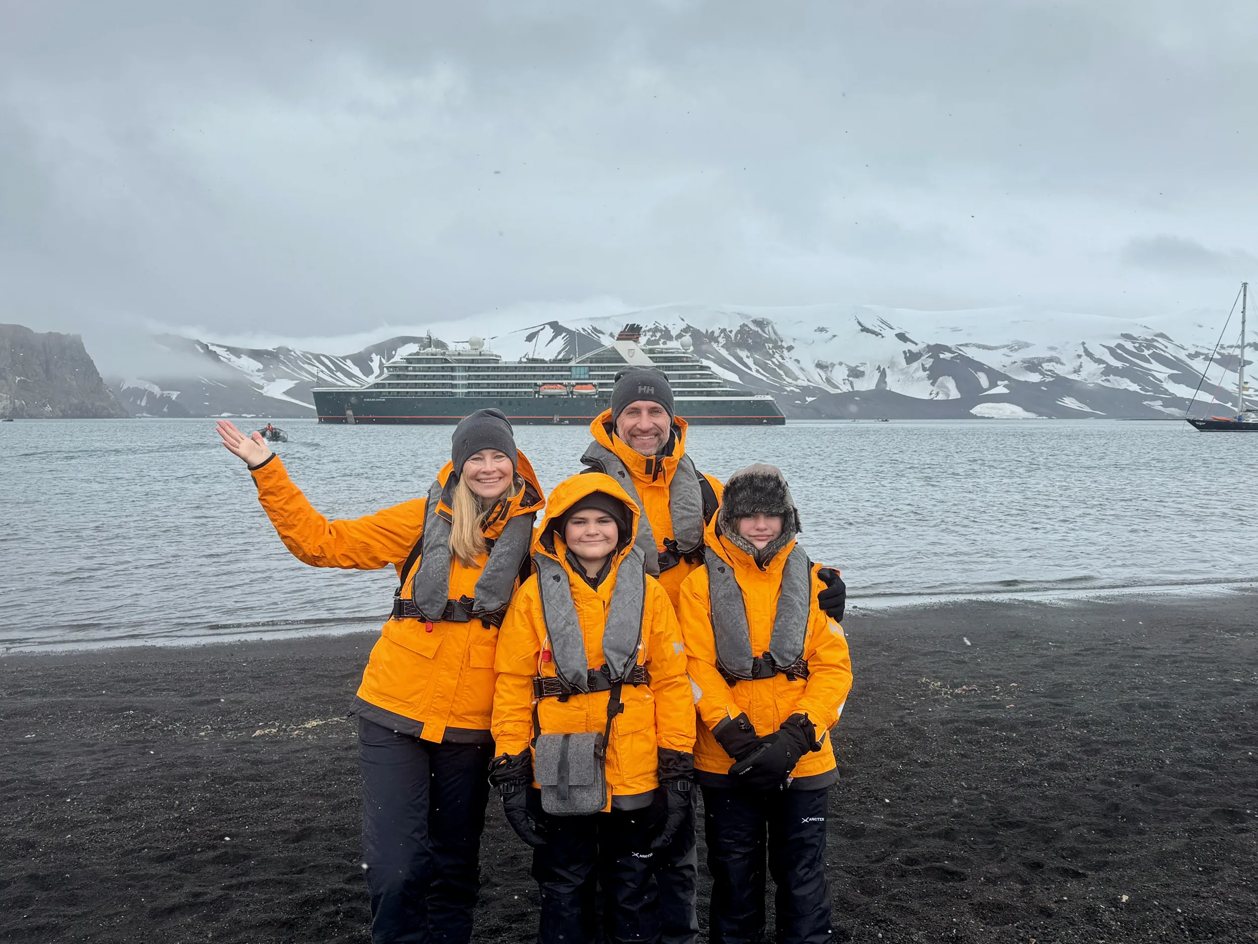 The Lockwood family poses in front of the Seabourn Venture/Pursuit in Antarctica