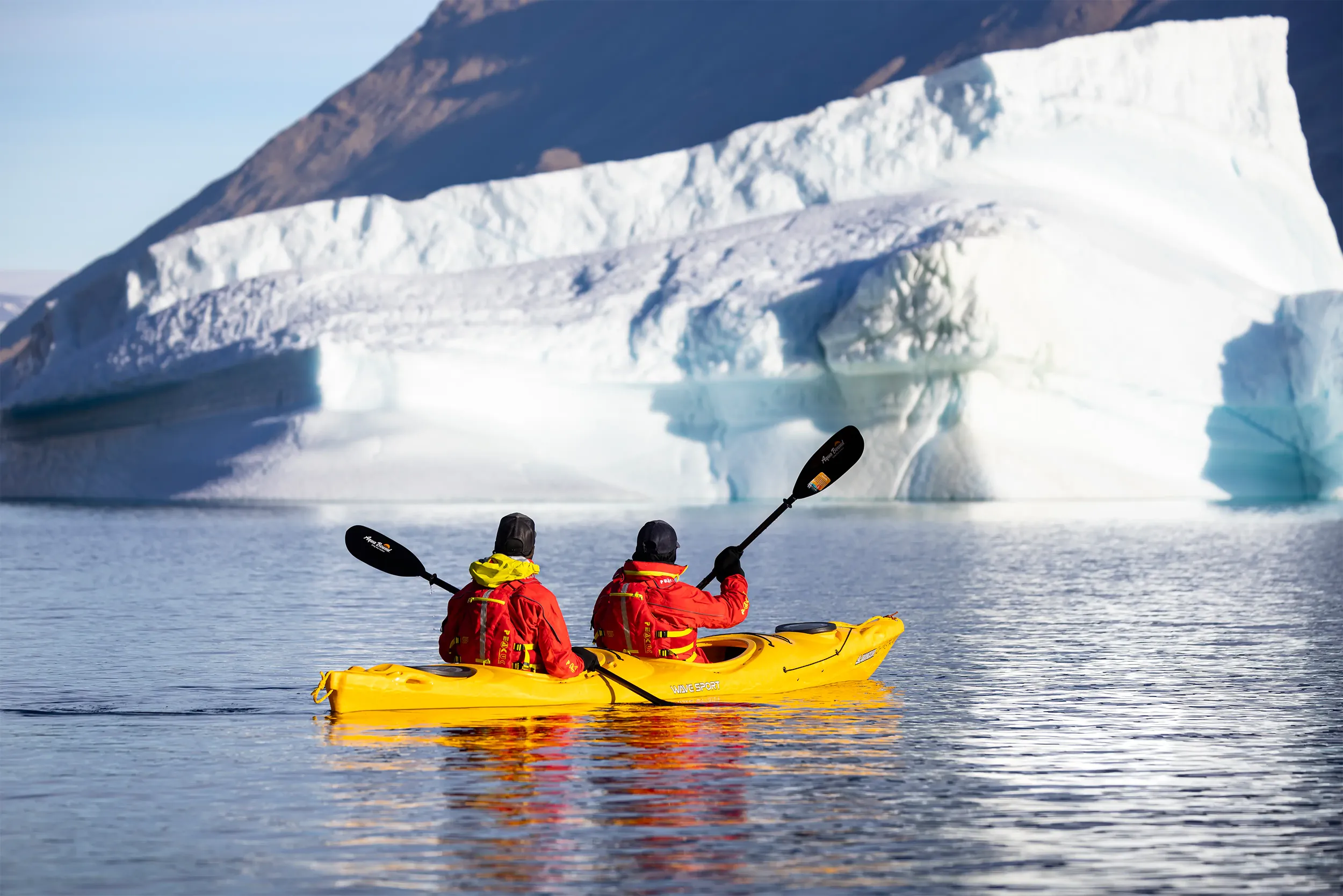Kayakers in front of an Antarctic iceberg