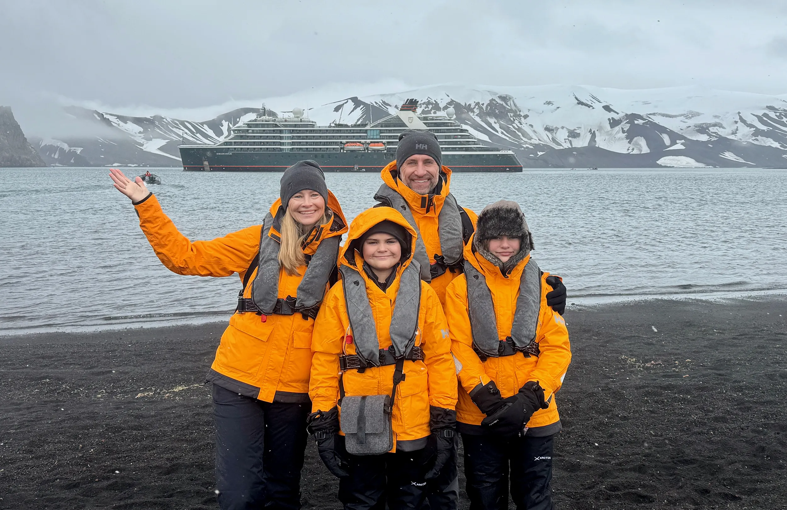 The Lockwood family poses on the shores of Deception Island in Antarctica