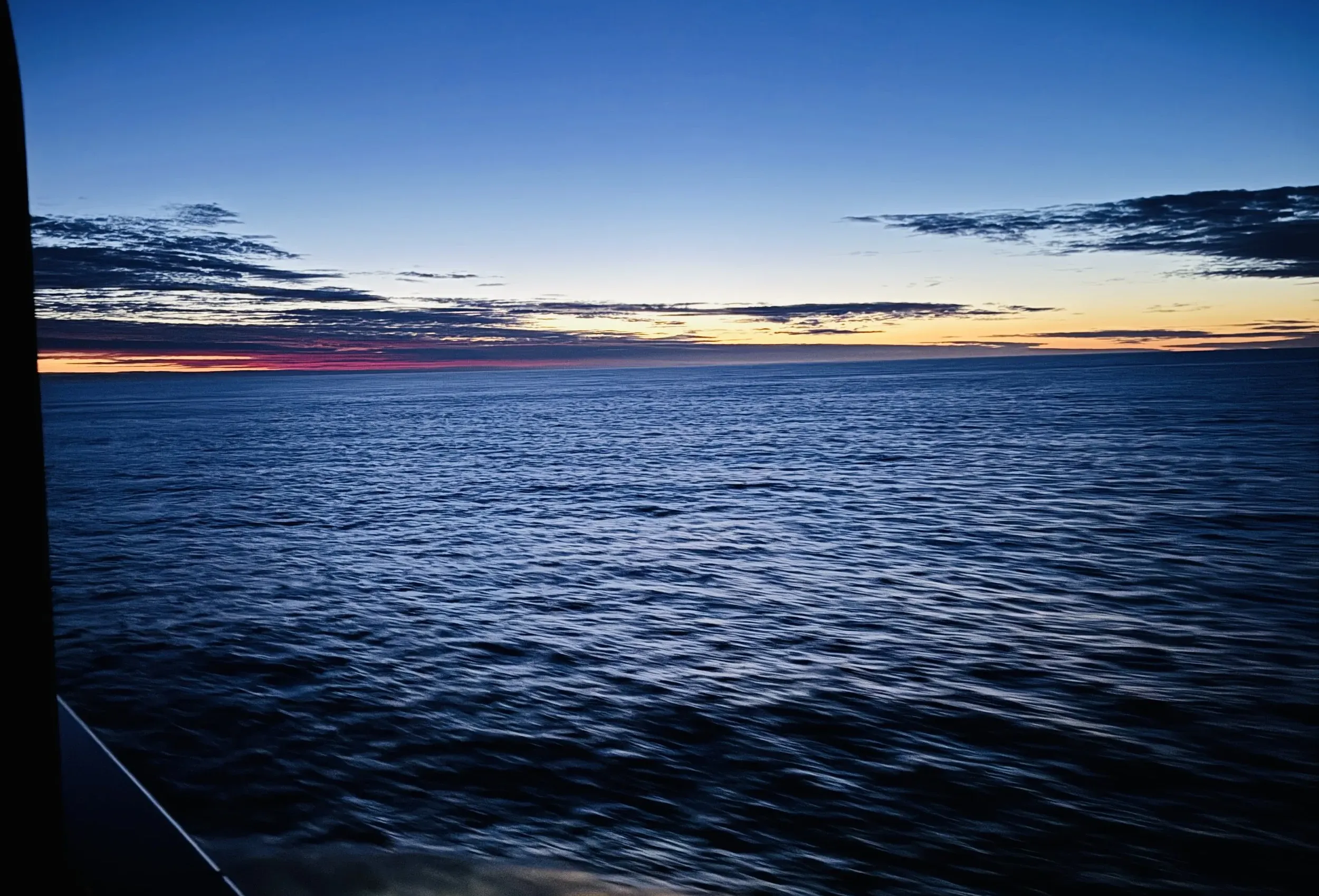 Sunset view of the Drake Passage from a cruise ship cabin