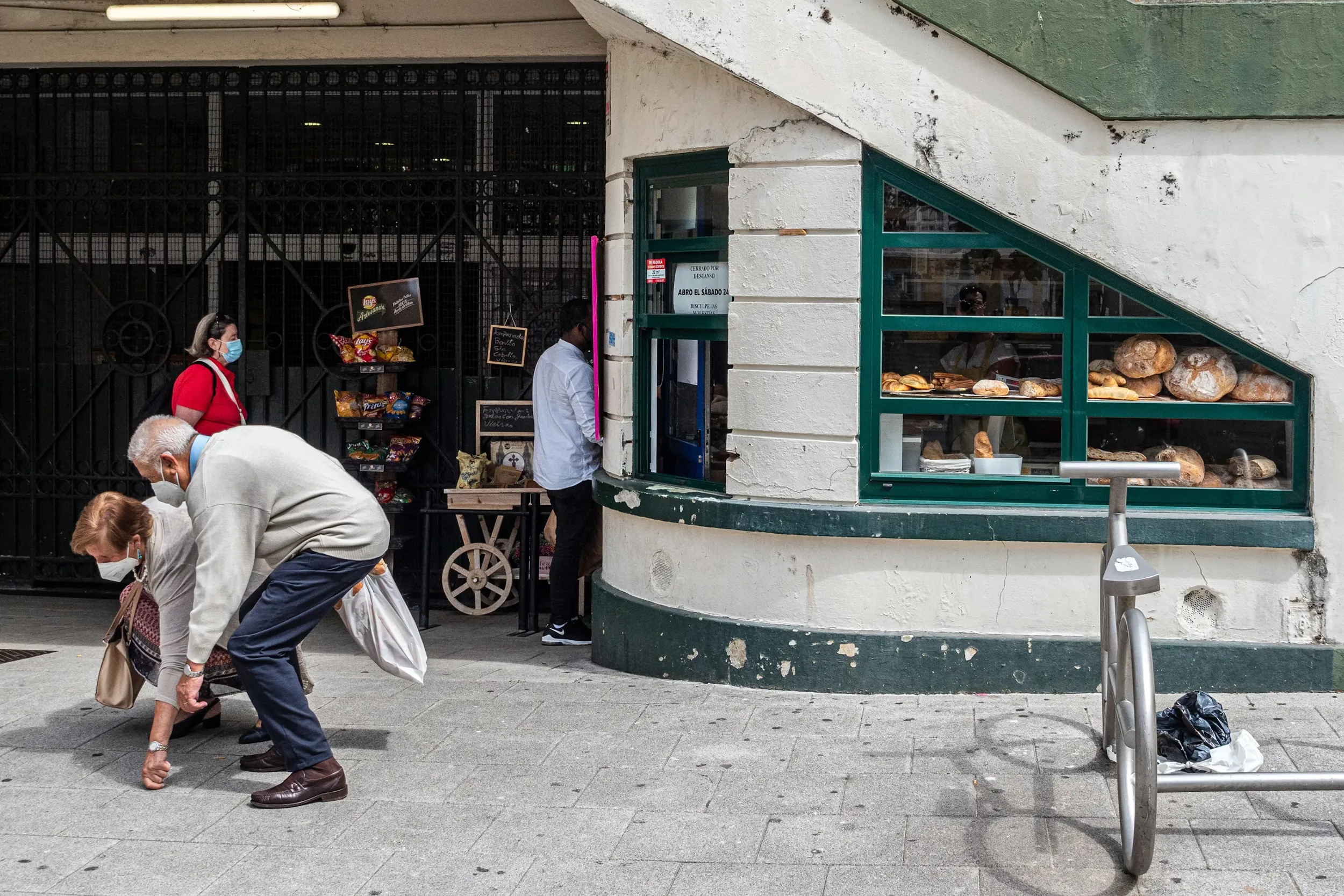 Locals on a sidewalk in La Coruna, Spain