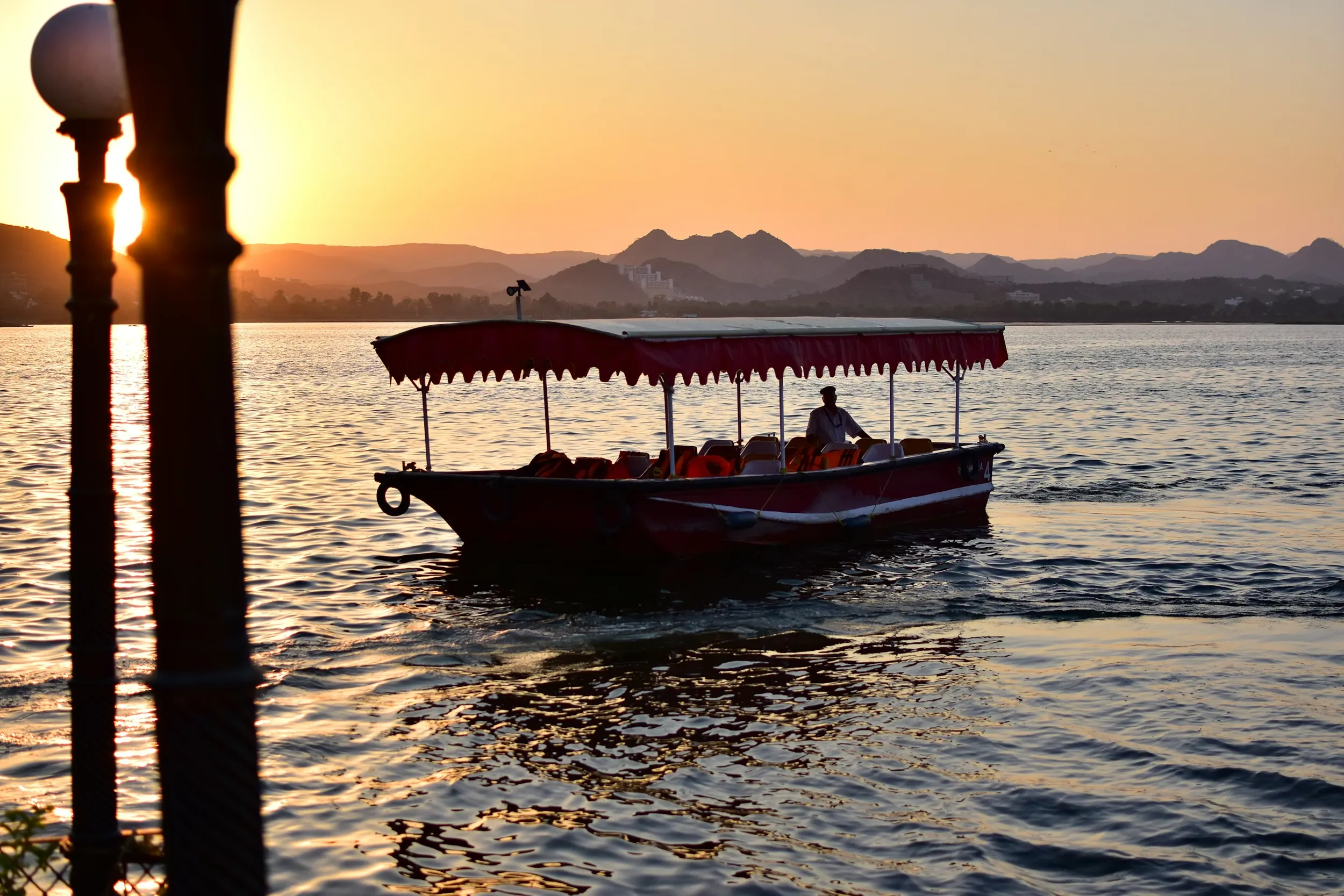 A small boat on the water in Udaipur