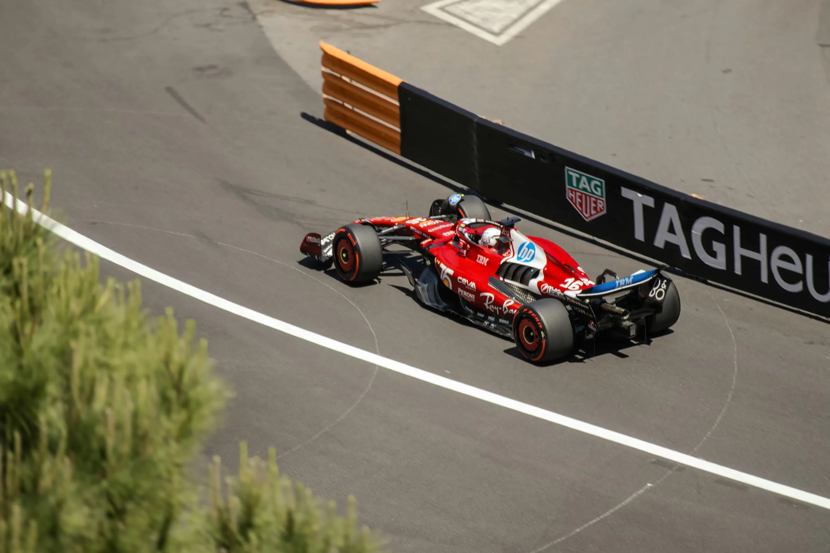 A Ferrari F1 race car drives through the street