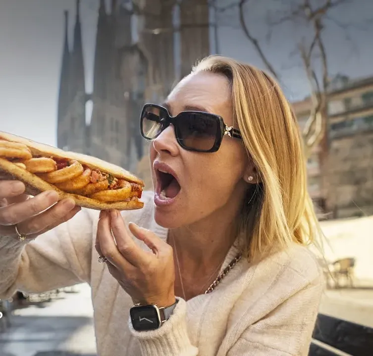 Erin Lockwood eating a massive sandwich in Barcelona