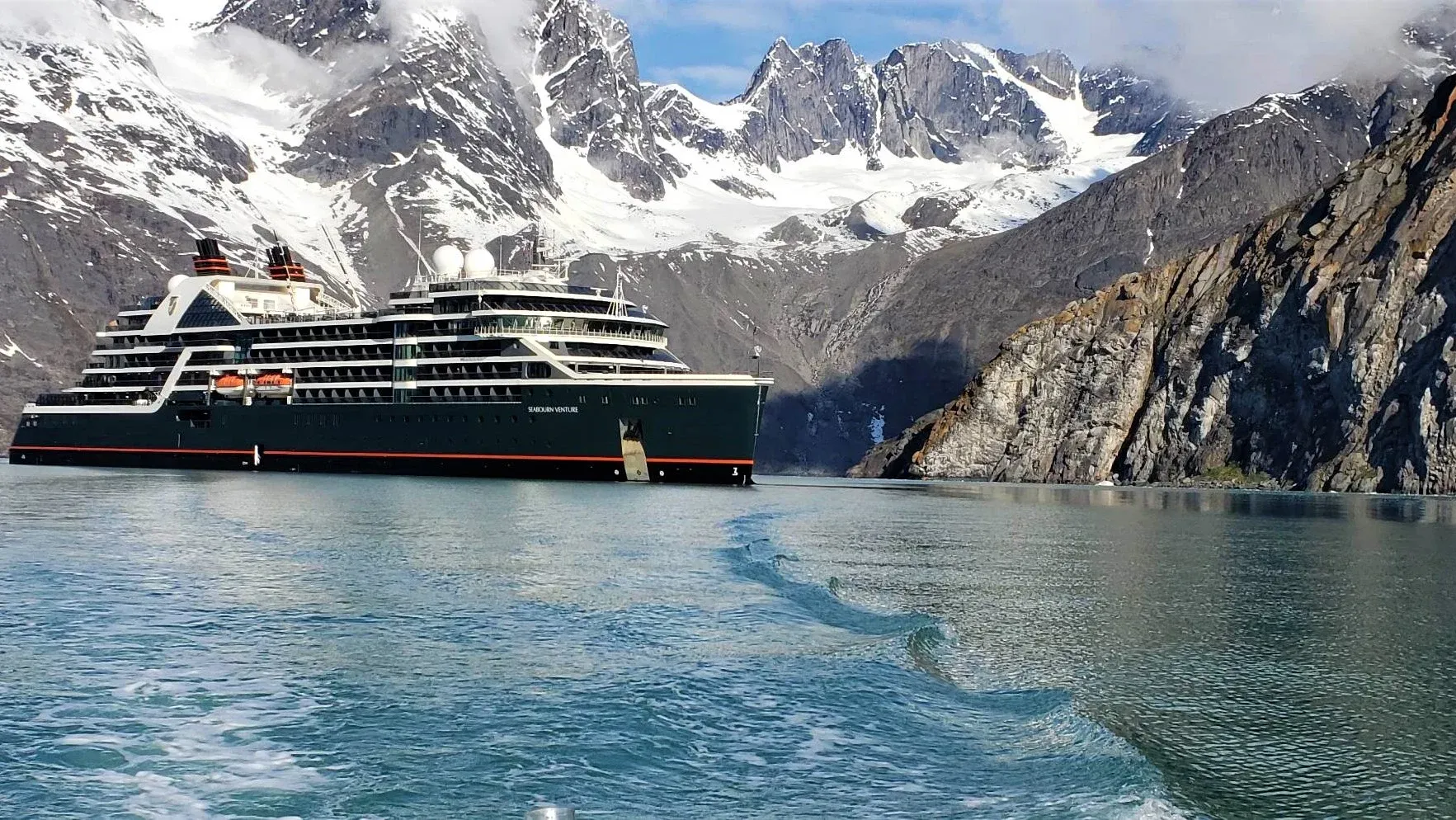 Seabourn Venture in a bay surrounded by mountains