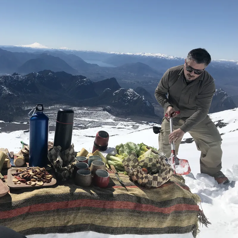 A man prepares an outdoor meal at &Beyond Vira Vira