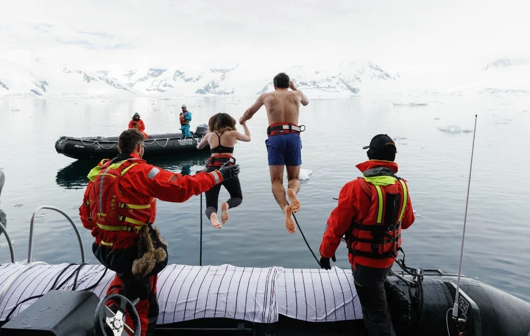 People taking the polar plunge in Antarctica