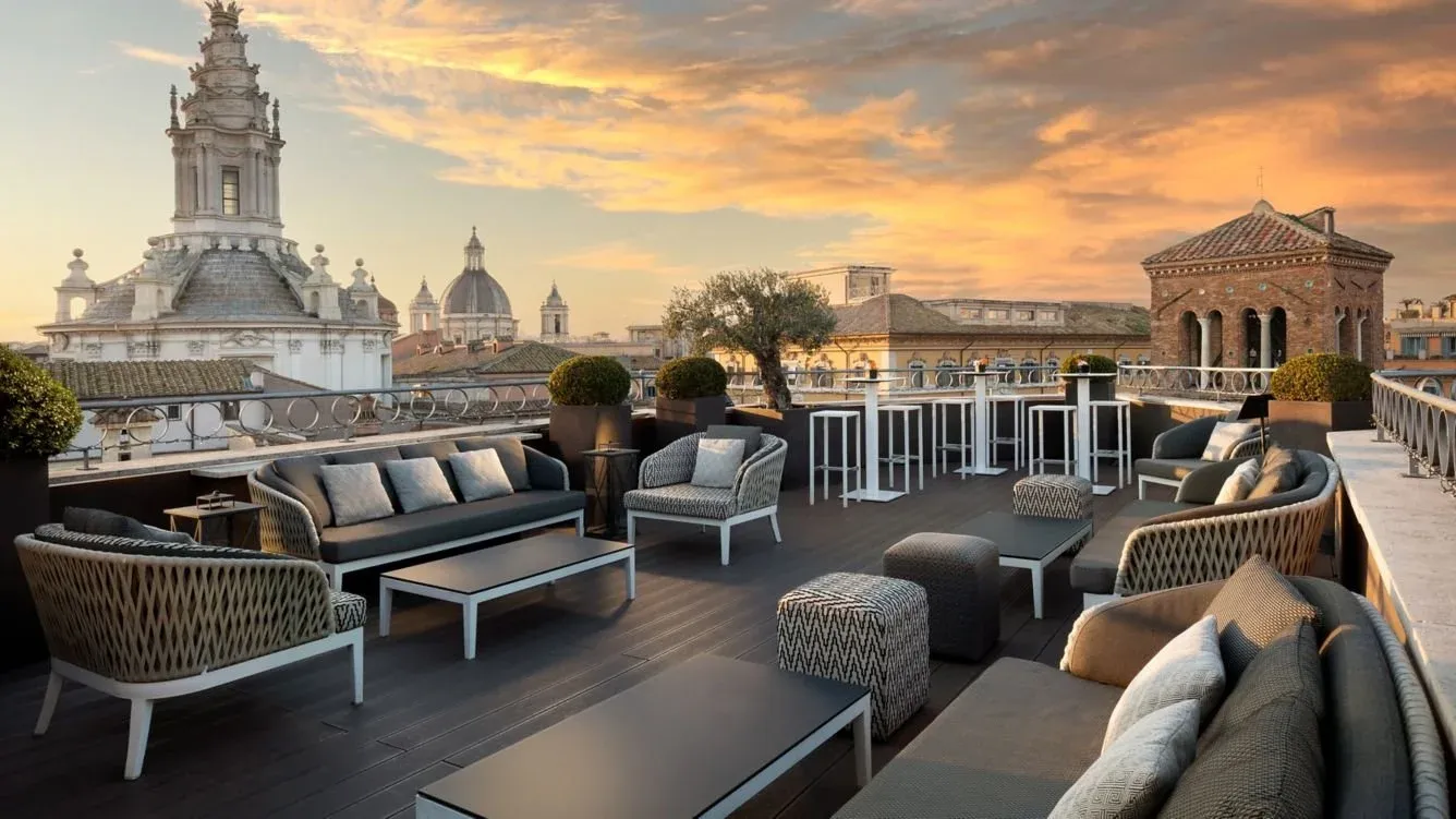 A hotel's rooftop patio with buildings in the distance