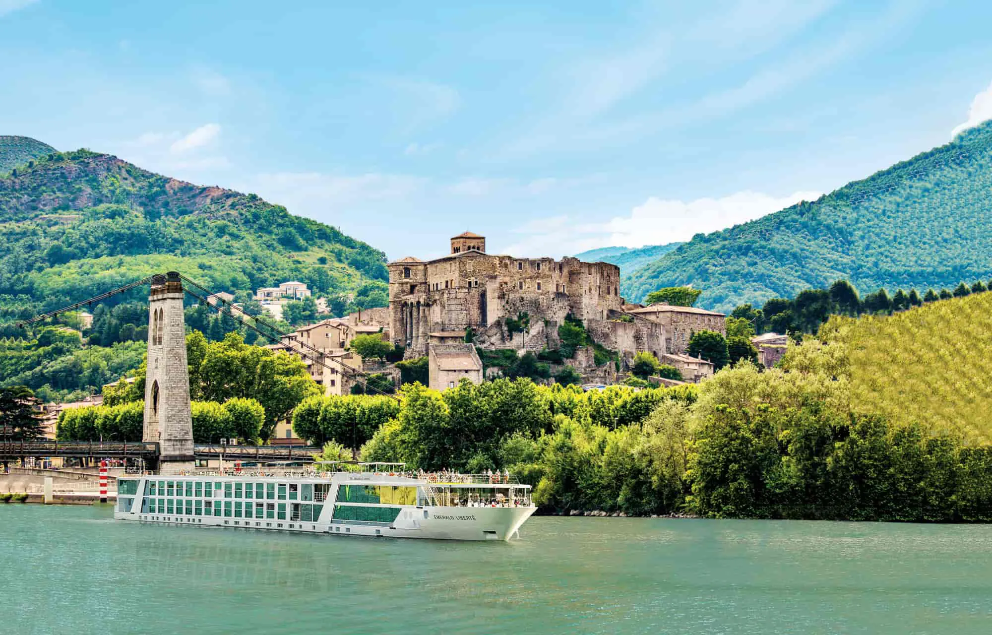 An Emerald river cruise ship in front of a castle