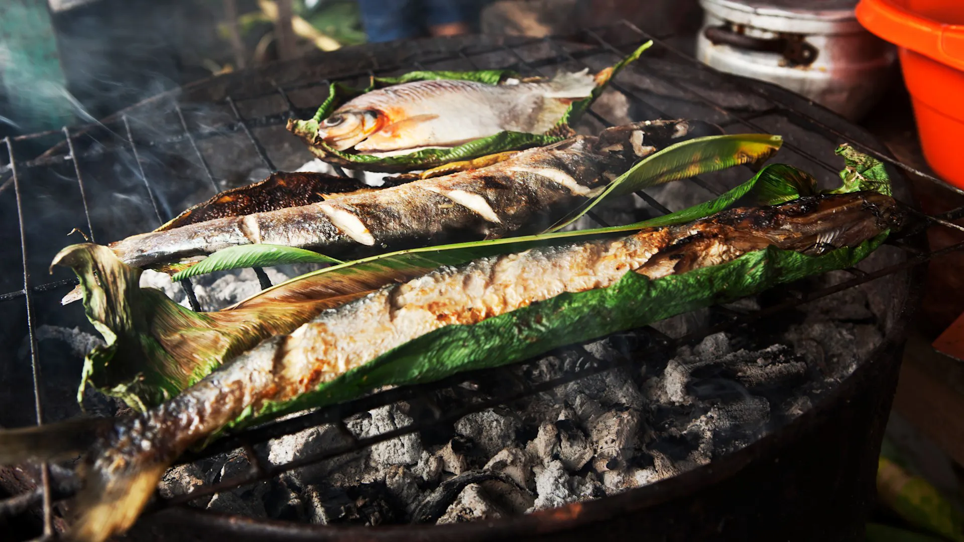 Fish cooking in leaves at Nauta market