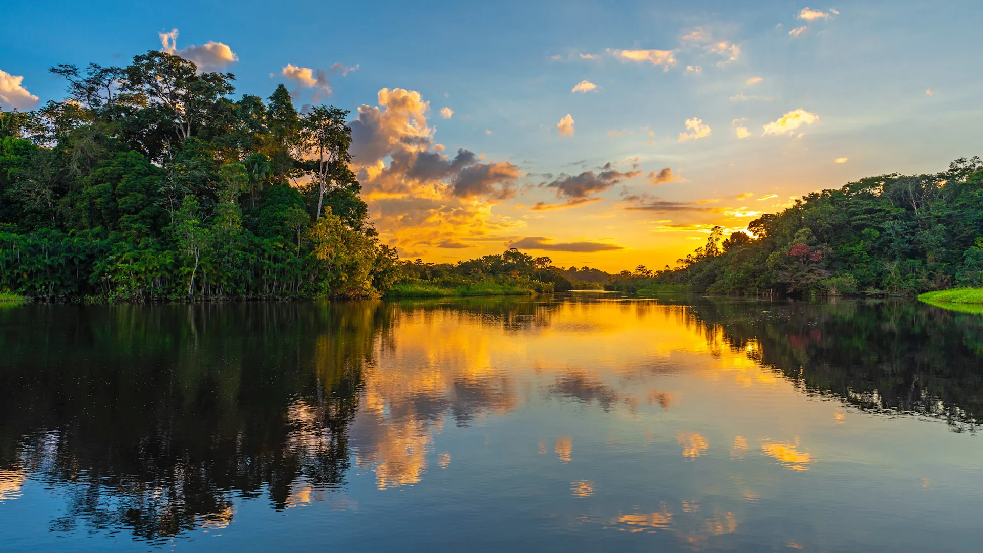 A sunset reflects off the Amazon river