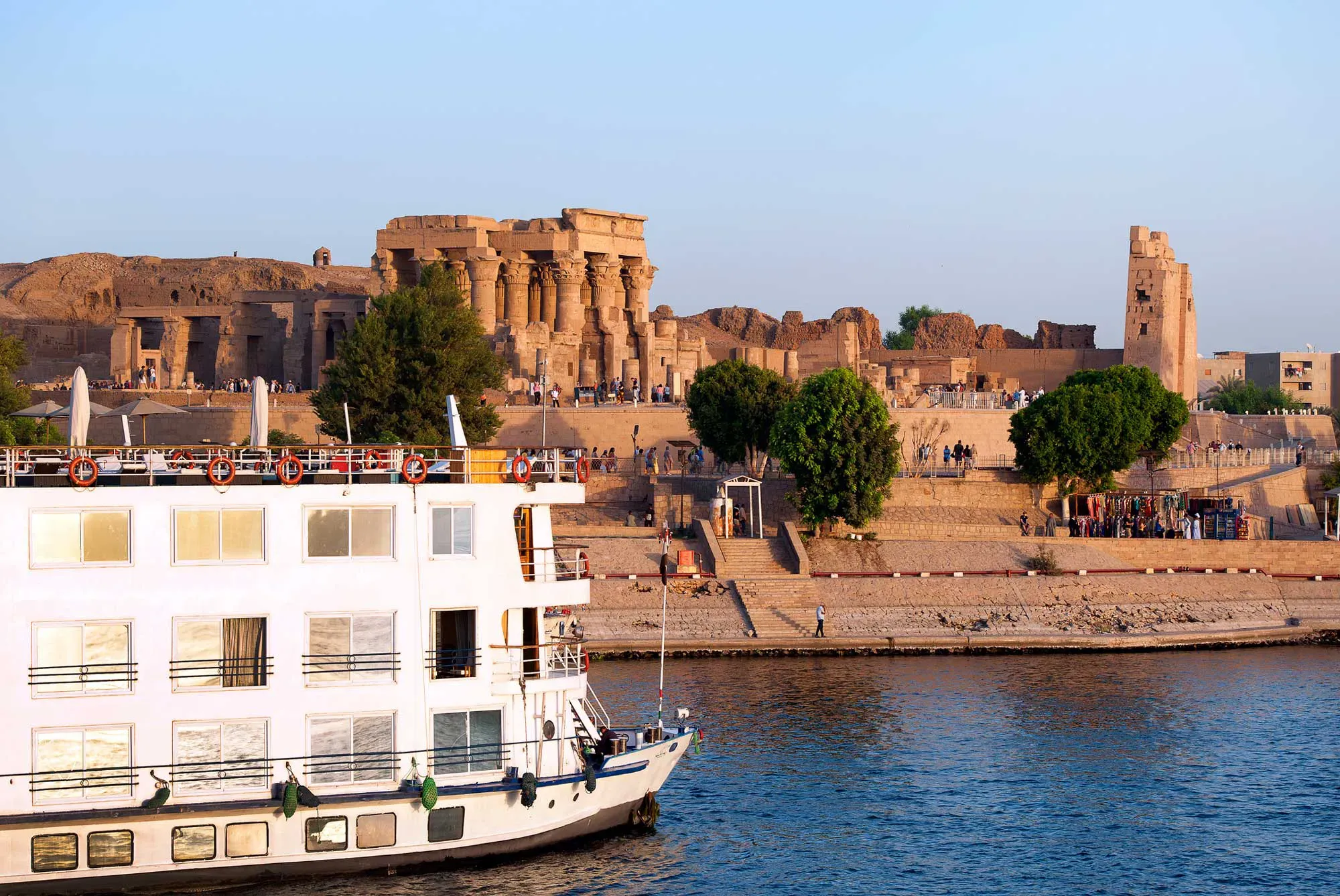 A Nile river boat sails past ancient ruins in Egypt