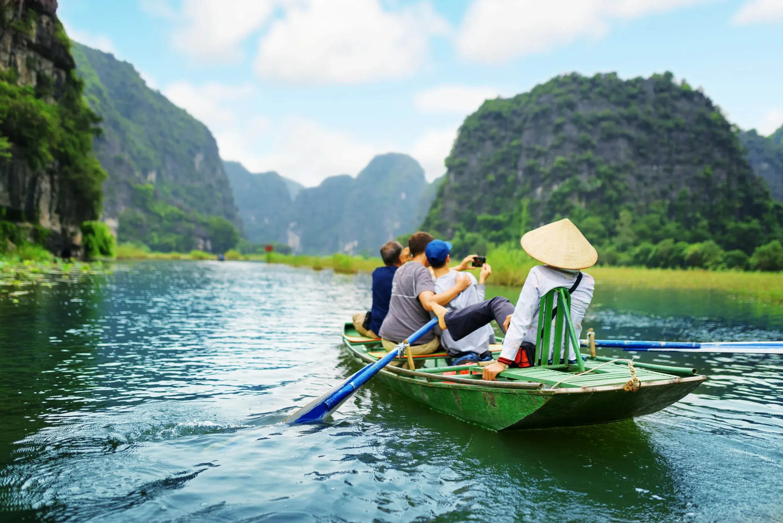 Tourists on a small boat in a Vietnamese river